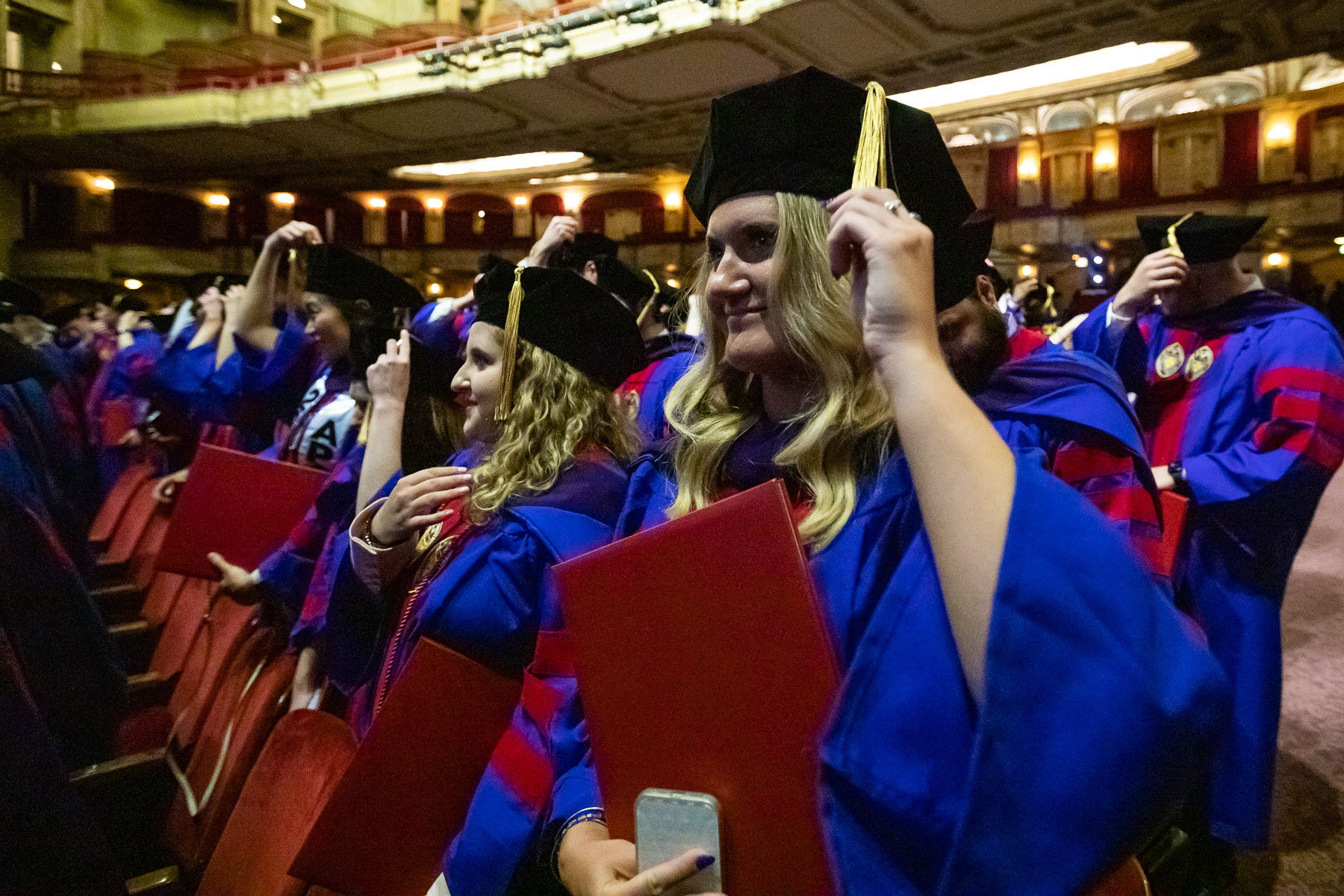 Students flip their tassels after receiving their degrees at the DePaul University College of Law commencement ceremony.